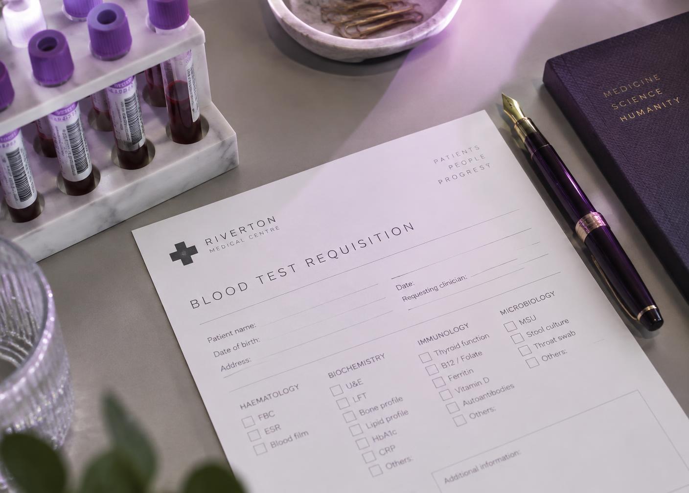 Laboratory requisition and specimen tubes on a clinician's desk